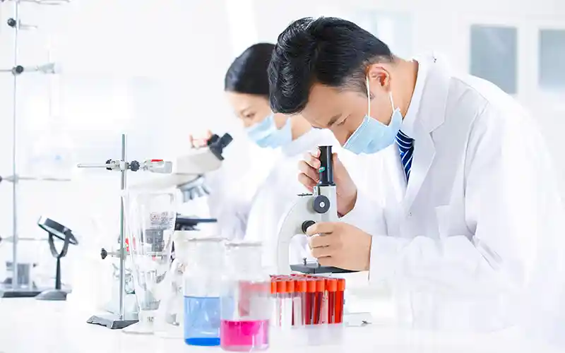 Lab technician testing plant extract samples for quality control and ingredient analysis